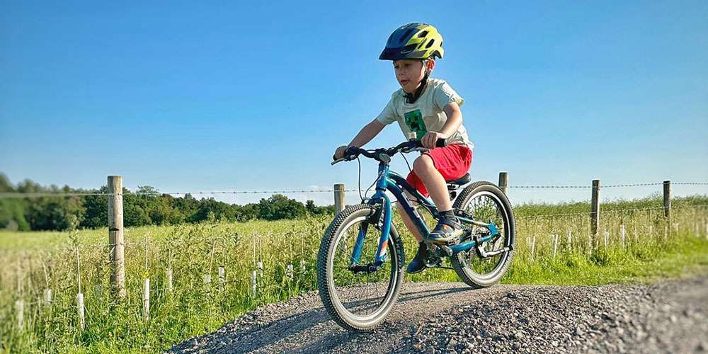 Bike track the picture shows a child on a bike going over a hump in the ground