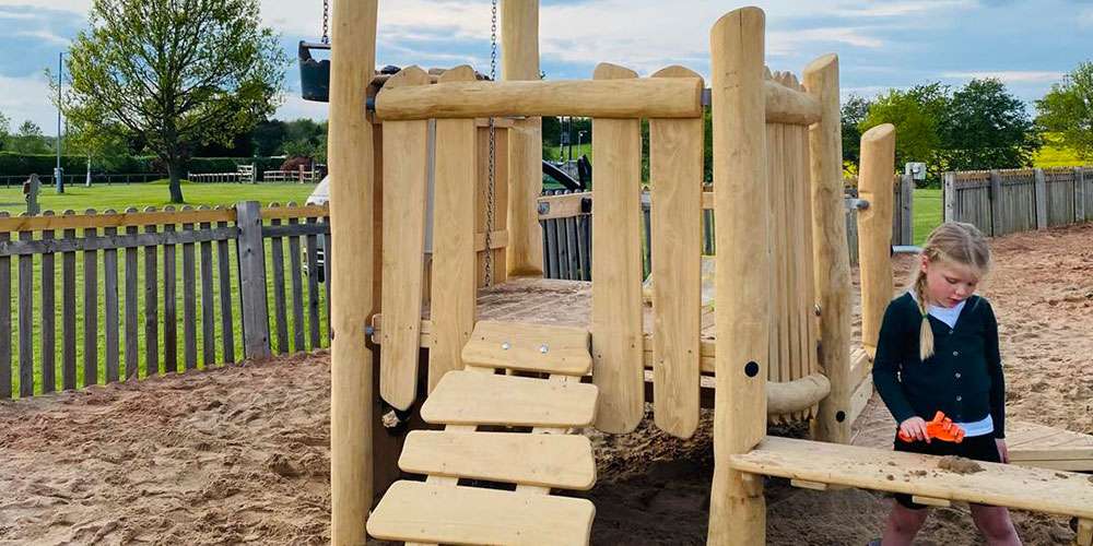 The sand play area A wooden structure set in a sand play area